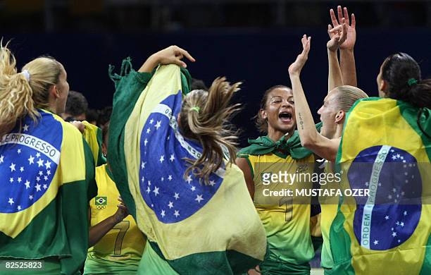 Brazil's team celebrates defeating the US during the women's volleyball gold medal match in the 2008 Beijing Olympic Games in Beijing on August 23,...