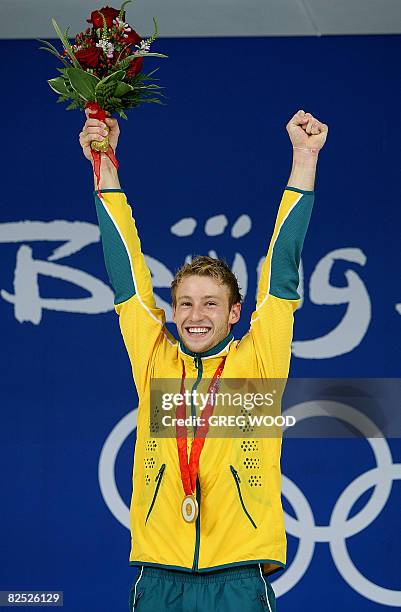 Matthew Mitcham of Australia celebrates after receiving his gold medal won during the final of the men's 10m platform diving at the 2008 Beijing...