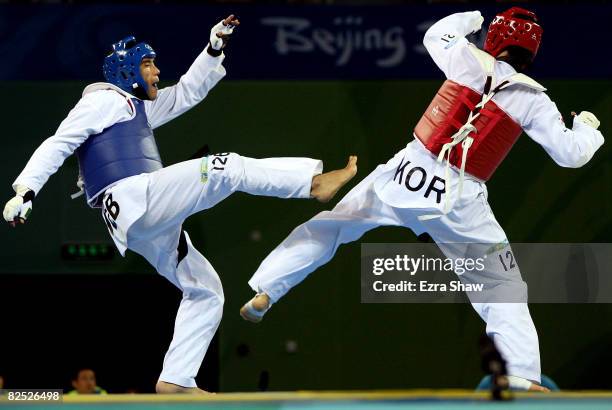 Dongmin Cha of Korea fights Akmal Irgashev of Uzbekistan in the Men's +80kg semifinal held at the University of Science and Technology Beijing...