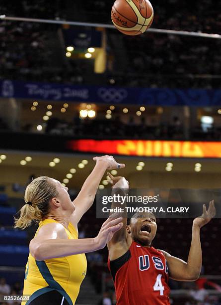 S Cappie Pondexter and Australia's Suzy Batkovic jump for the ball during the women's basketball gold medal match Australia against The US of the...