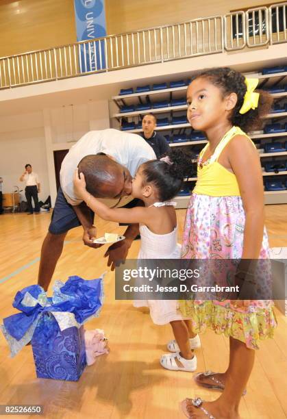 Kobe Bryant of the U.S. Men's Senior National Team kisses his daughters Nyla and Natalia Bryant during practice at the 2008 Beijing Summer Olympics...