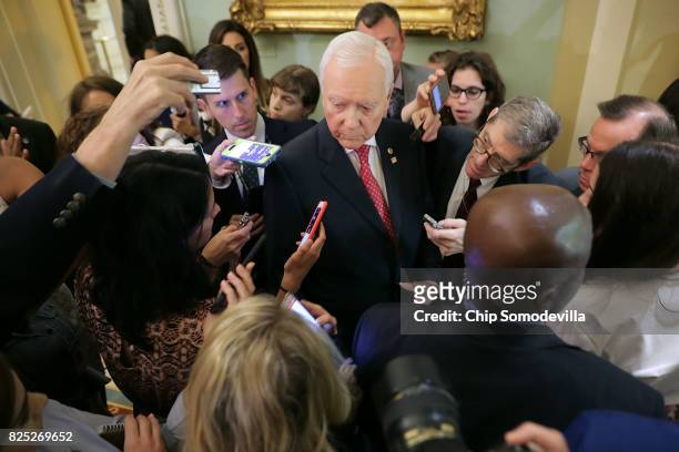 Sen. Orrin Hatch is surrounded by reporters before heading into the Senate Republican policy luncheon at the U.S. Capitol August 1, 2017 in...