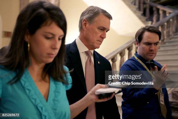 Sen. David Perdue heads into the Senate Republican policy luncheon at the U.S. Capitol August 1, 2017 in Washington, DC. After failing to pass...