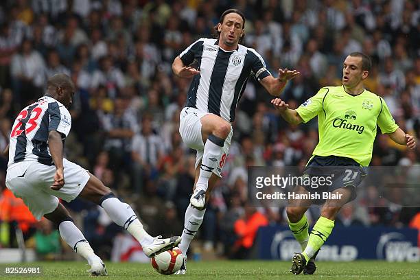 Abdoulaye Meite and Jonathan Greening of West Bromwich contest with Leon Osman of Everton during the Barclays Premier League match between West...