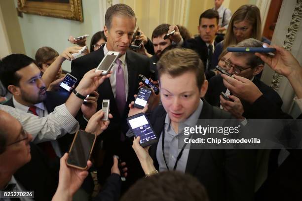 Sen. John Thune is surrounded by reporters before heading into the Senate Republican policy luncheon at the U.S. Capitol August 1, 2017 in...