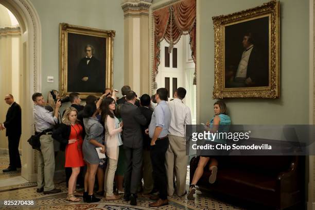 Reporters surround Sen. John Thune as he heads into the Senate Republican policy luncheon at the U.S. Capitol August 1, 2017 in Washington, DC. After...