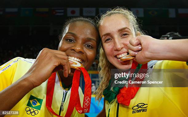 Fabiana Claudino and Thaisa Menezes of Brazil celebrate with their gold medals after they defeated the United States during the women's gold medal...