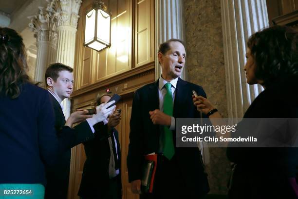 Sen. Ron Wyden talks with reporters before heading into the Senate Democratic policy luncheon at the U.S. Capitol August 1, 2017 in Washington, DC....