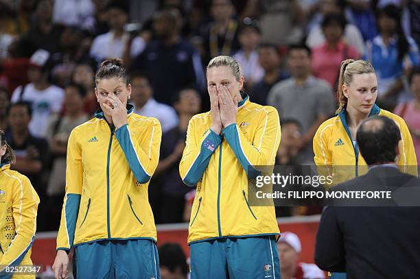 Australia's Hollie Grima, Australia's Suzy Batkovic and Australia's Penny Taylor cry on the podium after the women's basketball gold medal match of...