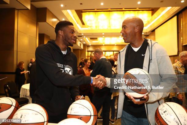 Emmanuel Mudiay of the Denver Nuggets and NBA Legend Bruce Bowen chats during the Basketball Without Borders Africa program at the Hyatt Regency...