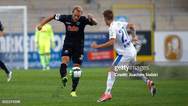 Nico Neidhart of Lotte challenges Ben Zolinski of Paderborn during the 3. Liga match between Sportfreunde Lotte and SC Paderborn 07 at Frimo Stadion...