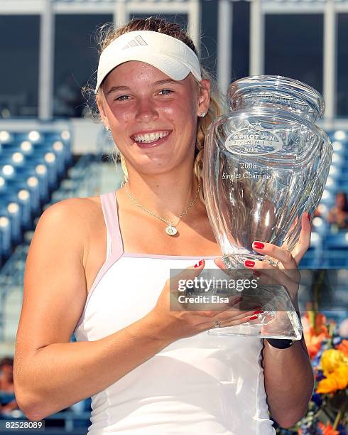 Caroline Wozniacki of Denmark poses with her championship trophy after she defeated Anna Chakvetadze of Russia during the women's singles...