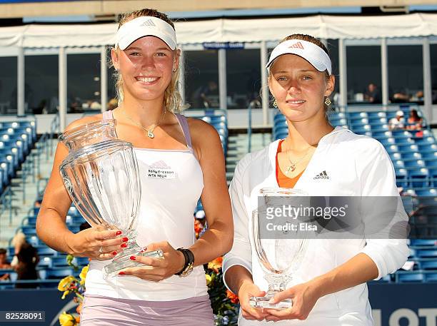 Caroline Wozniacki of Denmark poses with her championship trophy and Anna Chakvetadze of Russia holds the second place trophy during the women's...