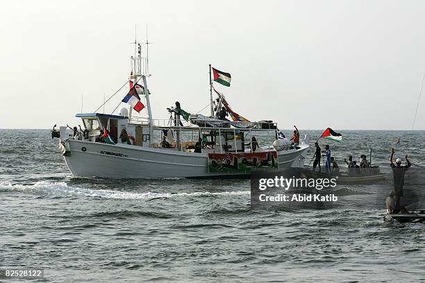 One of the two boats from the Free Gaza protest group arrives from Cyprus while Palestinians ride boats to welcome it August 23, 2008 in Gaza City,...