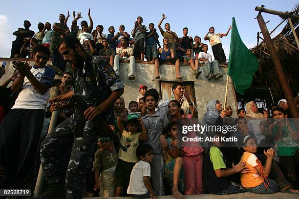 Palestinians watch two boats from the Free Gaza protest group arrives from Cyprus as they arrive August 23, 2008 in Gaza City, Gaza. Two boats...