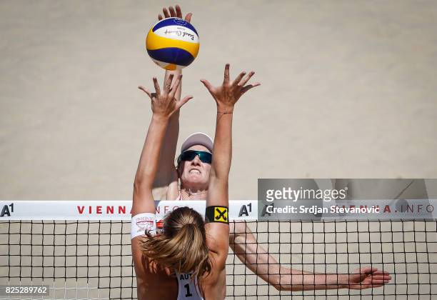 Teresa Strauss of Austria spikes the ball against Emily Day of USA during the Women's Pool A Main draw match between USA and Austria on August 01,...