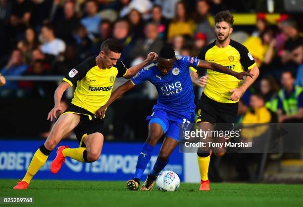 Ahmed Musa of Leicester City holds off a challenge from Matthew Lund of Burton Albion during the Pre-Season Friendly match between Burton Albion v...