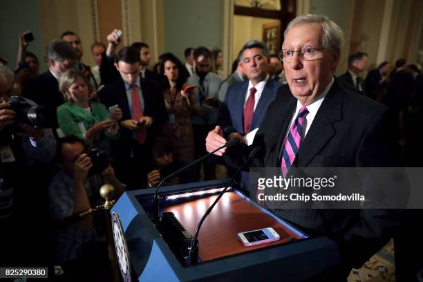 Senate Majority Leader Mitch McConnell talks with reporters with Sen. Cory Gardner following the Republican Senate policy luncheon at the U.S....