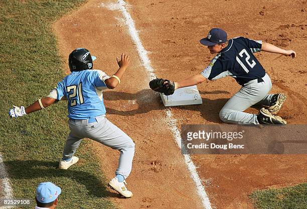 Keelen Obedoza of the West tries to avoid a tag by third baseman Bryce Jordan of the Southwest after overunning third base in the United States Final...