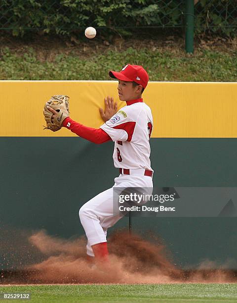 Centerfielder Ryo Motegi of Japan mis-plays a ball off the wall against Mexico in the International Final at Lamade Stadium on August 23, 2008 in...