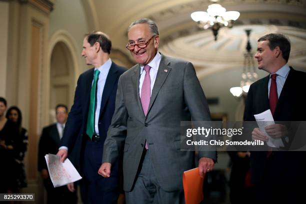 Senate Minority Leader Charles Schumer is joined by Sen. Ron Wyden and Sen. Michael Bennet for a news conference following the Senate Democratic...