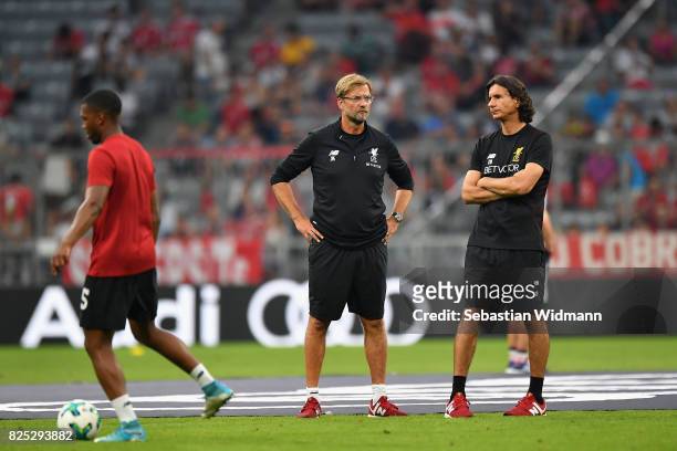 Jürgen Klopp, Head Coach of Liverpool FC speak to assistant coach, Zeljko Buvac prior to the Audi Cup 2017 match between Bayern Muenchen and...