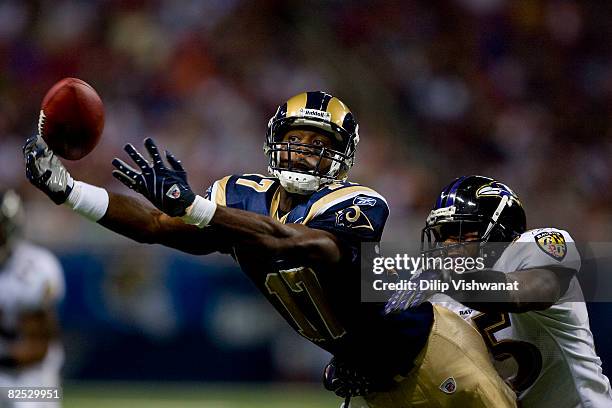 Donnie Avery of the St. Louis Rams attempts to make a catch against Corey Ivy of the Baltimore Ravens at the Edward Jones Dome August 23, 2008 in St....