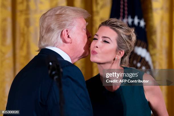 President Donald Trump kisses his daughter Ivanka Trump after speaking at an event with small businesses at the White House in Washington, DC, on...