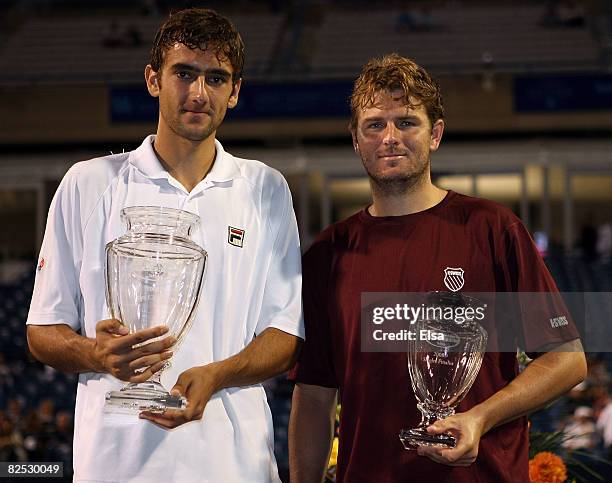 Marin Cilic of Croatia and Mardy Fish pose with their trophies after the men's singles championship match during Day 6 of Pilot Pen Tennis on August...