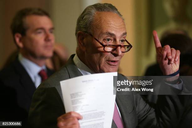 Senate Minority Leader Sen. Chuck Schumer speaks as Sen. Michael Bennet looks on during a media briefing at the Capitol August 1, 2017 in Washington,...