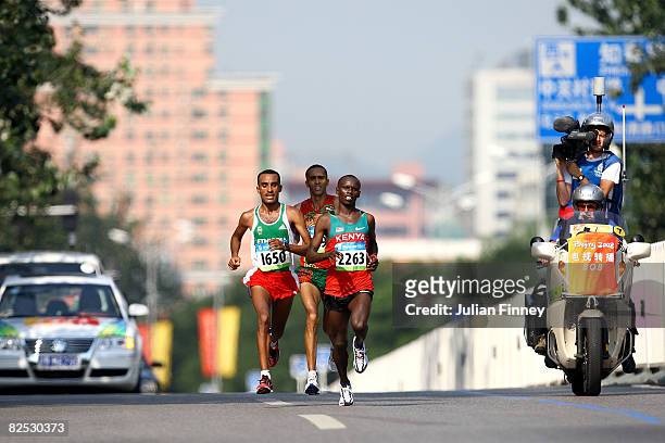 Merga Deriba of Ethiopia, Jaouad Gharib of Morocco and Sammy Wanjiru of Kenya compete during the Men's Marathon on the way to the National Stadium...