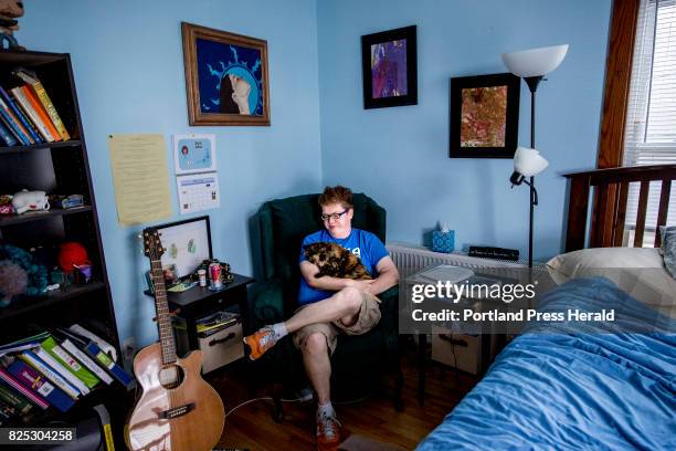 Drew Floyd of Portland sits in a chair in her bedroom where she meditates and spends time with her animals like cat Lucy, as she deals with chronic...