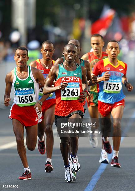 Sammy Wanjiru of Kenya, Merga Deriba of Ethiopia and Yared Asmerom of Eritrea compete during the Men's Marathon on the way to the National Stadium...