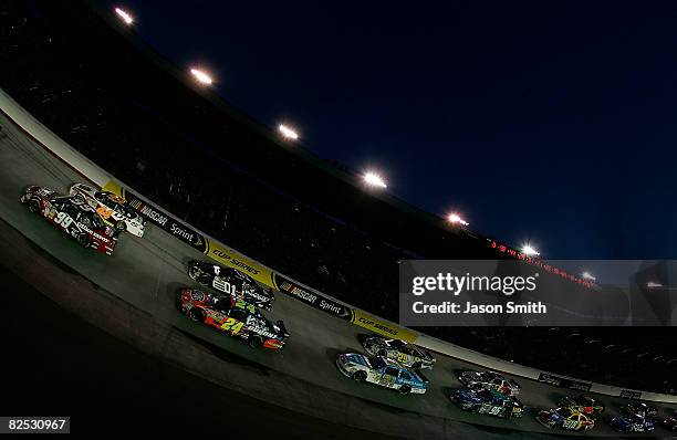 Carl Edwards, driver of the Office Depot Ford, and David Reutimann, driver of the UPS Toyota, lead the field to the start of the NASCAR Sprint Cup...