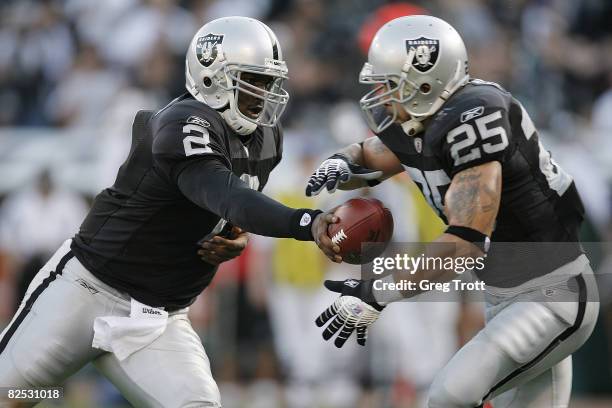 Quarterback JaMarcus Russell of the Oakland Raiders hands off to running back Justin Fargas against the Arizona Cardinals during a preseason game on...