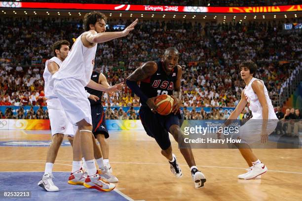 Kobe Bryant of the United States drives to the basket in between Pau Gasol and Ricky Rubio of Spain in the gold medal game during Day 16 of the...
