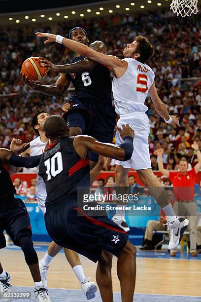LeBron James of the United States drives to the basket over the defense of Rudy Fernandez of Spain in the gold medal game during Day 16 of the...