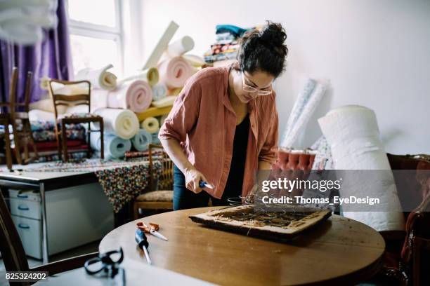 craftswoman refurbishing old chair seat - upholstery worker stock pictures, royalty-free photos & images