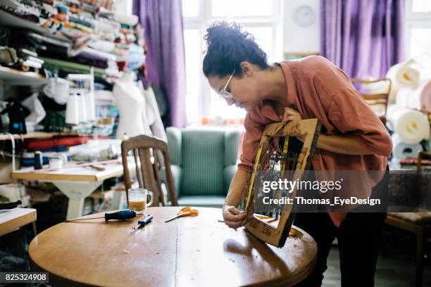 small business owner measuring chair seat in workshop - renovation of upholstered furniture stock pictures, royalty-free photos & images