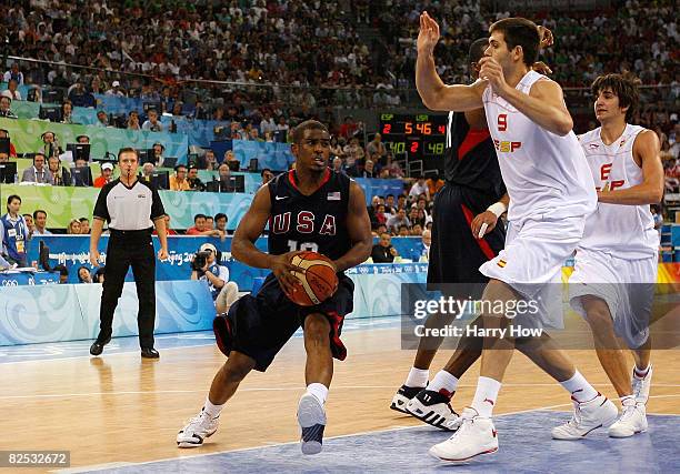 Chris Paul of the United States drives to the basket against Felipe Reyes of Spain in the gold medal game during Day 16 of the Beijing 2008 Olympic...