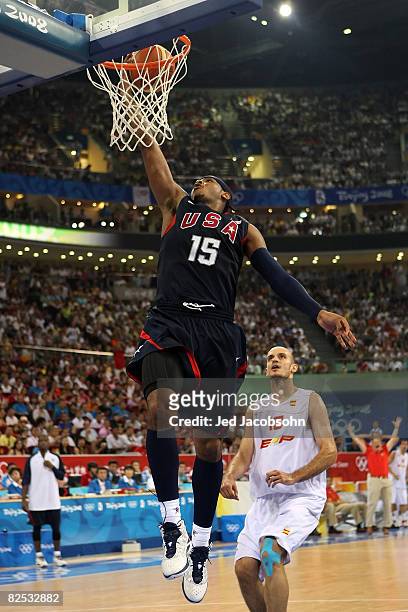 Carmelo Anthony of the United States lays the ball up past Carlos Jimenez of Spain in the gold medal game during Day 16 of the Beijing 2008 Olympic...