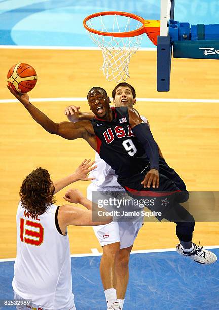 Dwyane Wade of the United States drives to the basket over the defense of Marc Gasol of Spain during the gold medal game against Spain during Day 16...