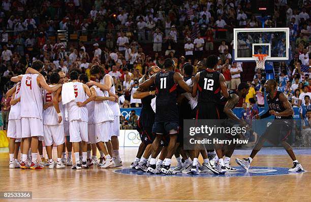 Kobe Bryant of the United States joins his teammates at center court as they celebrate defeating Spain in the gold medal game during Day 16 of the...