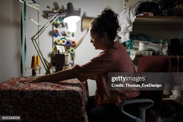 craftswoman working late at her sewing machine - renovation of upholstered furniture stock pictures, royalty-free photos & images