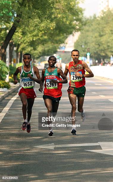 Merga Deriba of Ethiopia, Sammy Wanjiru of Kenya and Jaouad Gharib of Morocco compete in the Men's Marathon that ends in the National Stadium during...