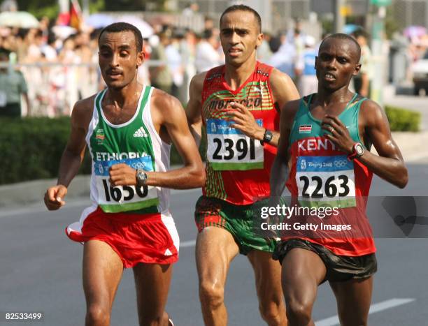 Merga Deriba of Ethiopia, Jaouad Gharib of Morocco and Sammy Wanjiru of Kenya compete in the Men's Marathon that ends in the National Stadium during...