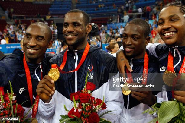 Kobe Bryant, LeBron James, Dwyane Wade and Carmelo Anthony of the United States hold up their medals after defeating Spain in the gold medal game...