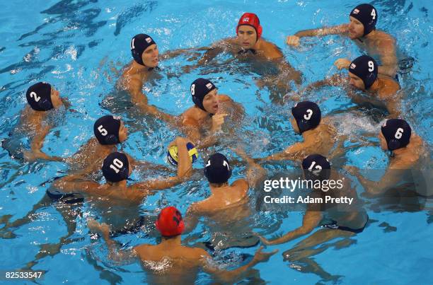 Tony Azevedo of the United States addresses his team in the pool before the start of the gold medal water polo match between Hungary and the United...
