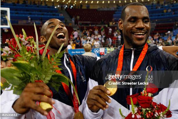 Kobe Bryant and LeBron James of the United States celebrate during the medal ceremony after defeating Spain 118-107 in the gold medal game during Day...