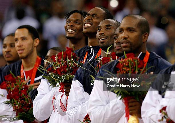 Carmelo Anthony, Tayshan Prince, Chris Bosh, Dwight Howard, Kobe Bryant, Dwyane Wade and Michael Redd of the United States salute as their countries...